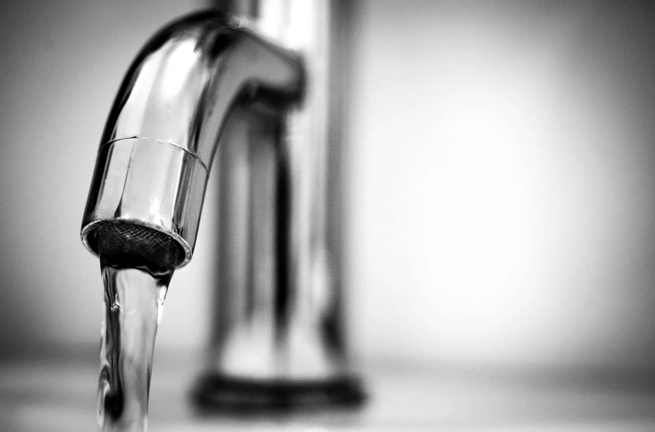 Fresh drinking water flowing from a modern stainless steel tap, symbolizing the clean and safe tap water available throughout Iceland