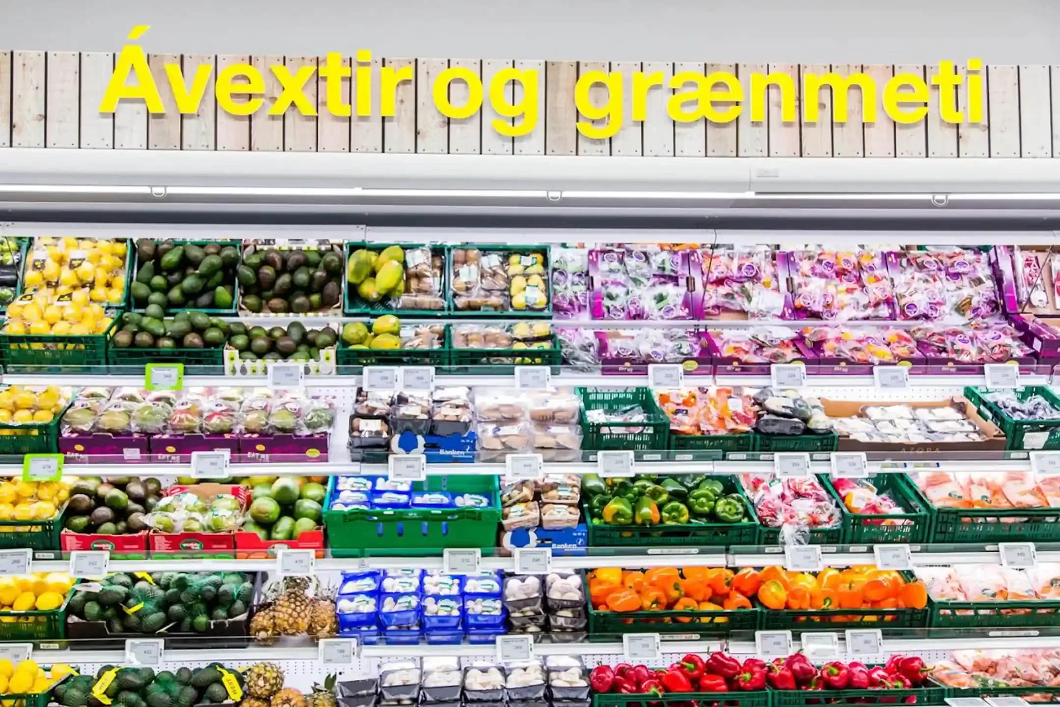 Fresh produce section in an Icelandic supermarket showing fruits and vegetables for travelers buying groceries in Iceland