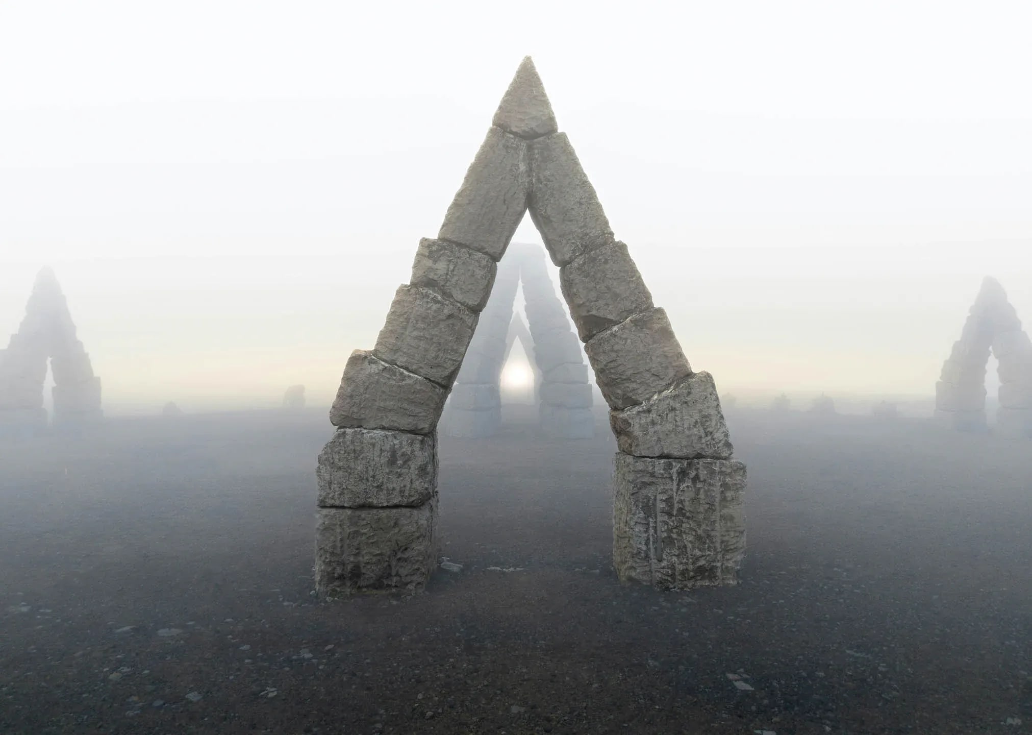 Fog covered Arctic Henge Iceland stone arch rising from a barren volcanic landscape with multiple stone triangles fading into the mist.