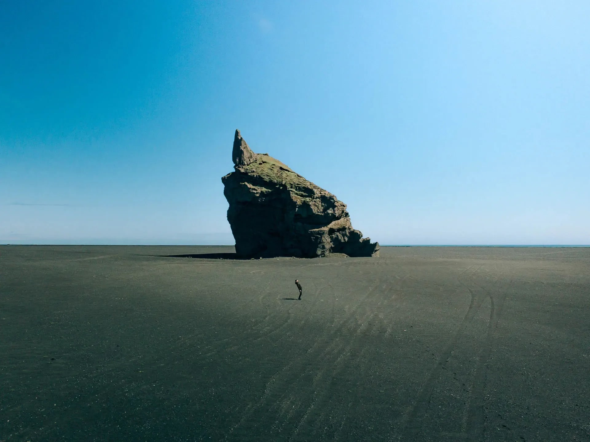 Campervan parked on a remote Icelandic coastline, showing how road trip travel can reduce costs when exploring Iceland in USD